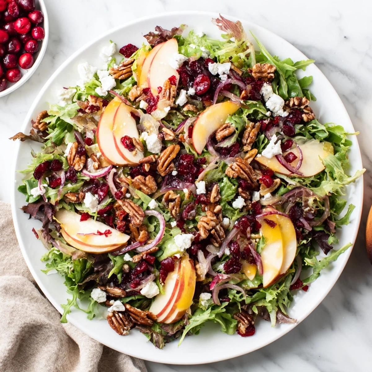 Close-up of a vibrant Seasonal Cranberry and Walnut Celebration Salad is bursting with color, perfect for Thanksgiving.