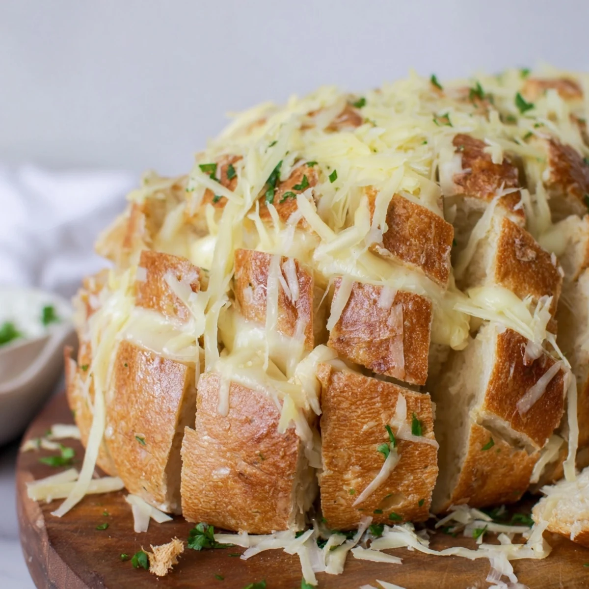 Golden-brown Cheesy Garlic Pull-Apart Bread with melted cheese and herbs, ready to be pulled apart.