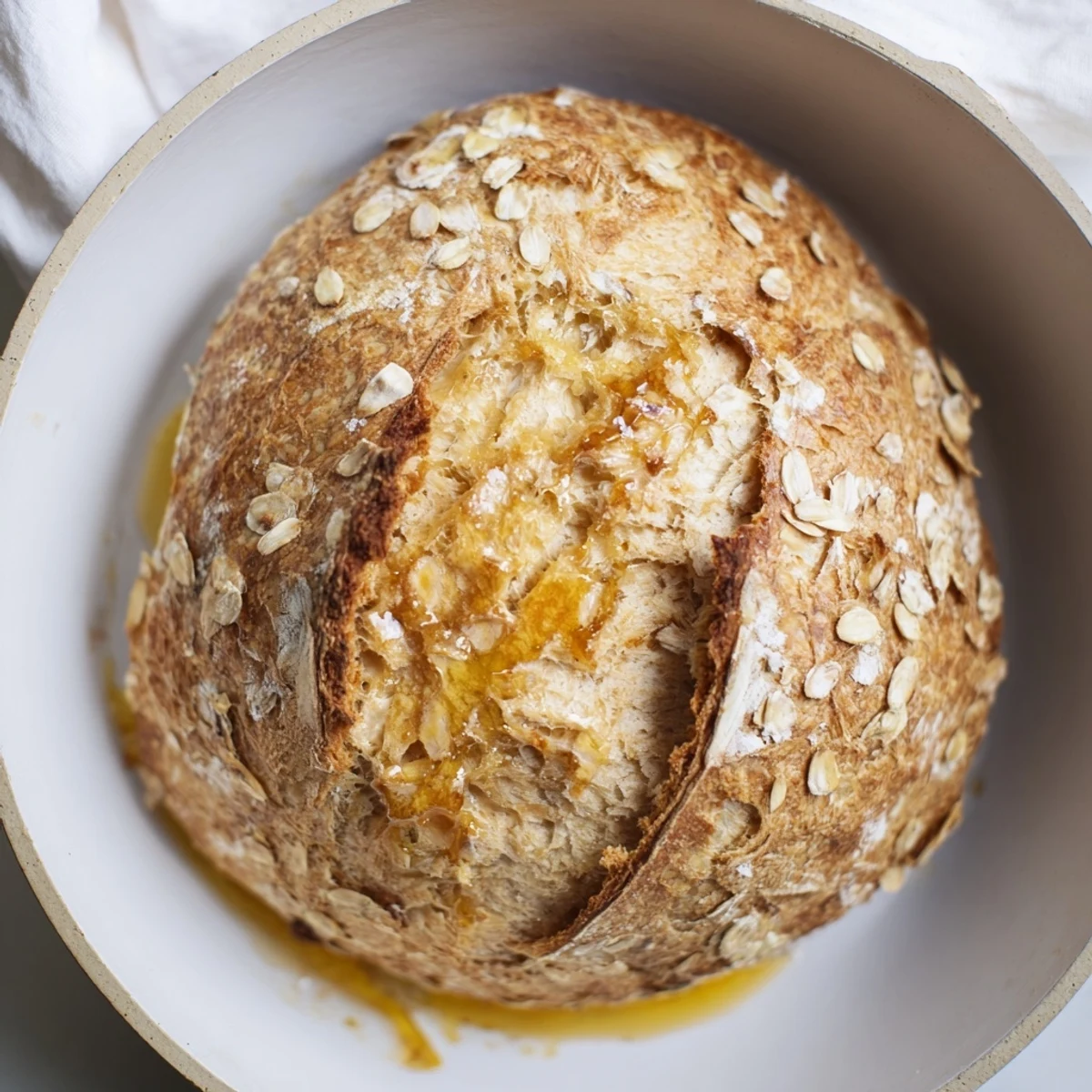 Close-up of freshly baked skillet cornbread; a sweet honey butter glaze coats the top.