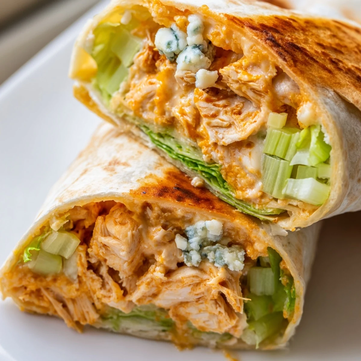 Savory Buffalo Chicken Dip Wrap, loaded with cheese and lettuce, ready to slice and enjoy.