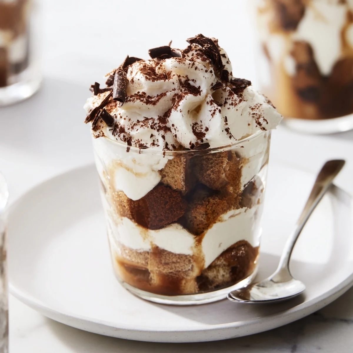 Creamy layers of mascarpone and espresso-soaked ladyfingers in festive Deconstructed Tiramisu Shots.
