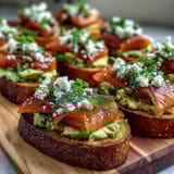 Creamy avocado spread and smoked salmon on toasted sourdough, perfect for a customizable spring brunch with friends.  