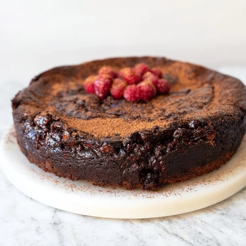 A slice of this decadent dark chocolate brownie tart showcases its fudgy texture and rich flavor.