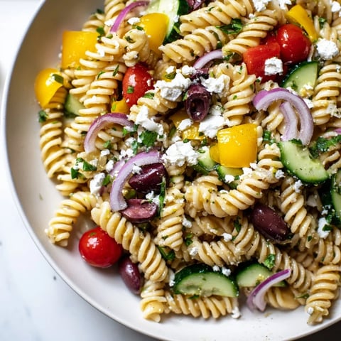 Vibrant Lemon Pasta Salad featuring fresh tomatoes and herbs, perfect for a picnic spread.