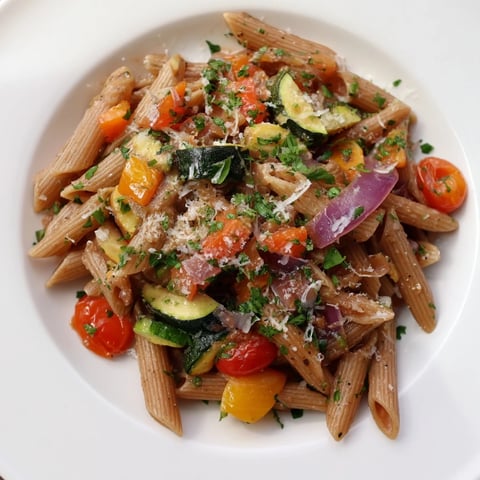 Lentil pasta with vegetables: a close-up image of the vibrant, roasted vegetables combined with pasta.