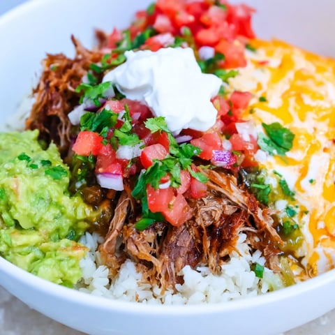 Chipotle Burrito Bowl Copycat: A generous bowl layered with flavorful carnitas and creamy queso.