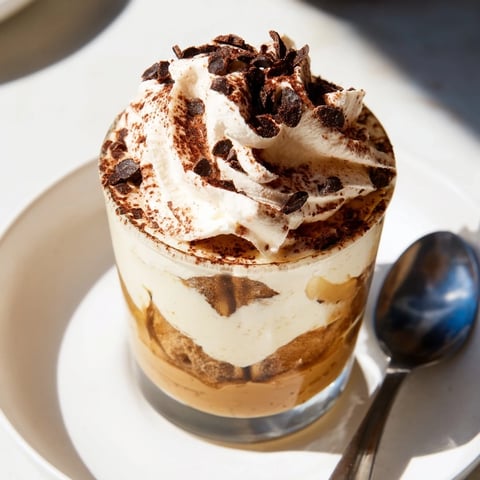 Deconstructed Tiramisu Shots in small glasses dusted with cocoa powder for a sweet treat.