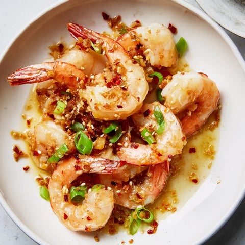 Golden Korean Garlic Butter Shrimp, sizzling from the skillet, ready to serve with lemon wedges.