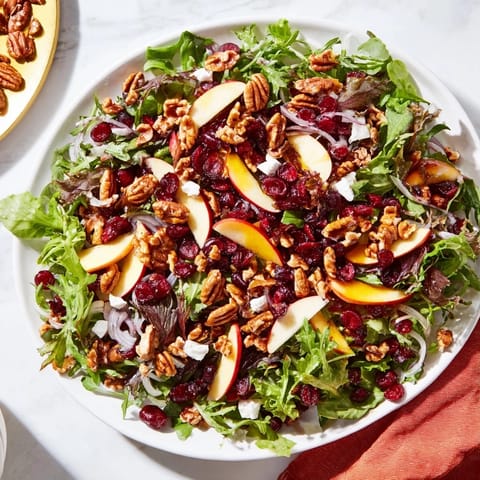 Festive Seasonal Cranberry and Walnut Celebration Salad with bright red cranberries and walnuts, ready to eat.