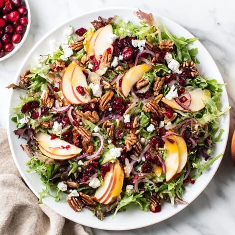 Close-up of a vibrant Seasonal Cranberry and Walnut Celebration Salad is bursting with color, perfect for Thanksgiving.