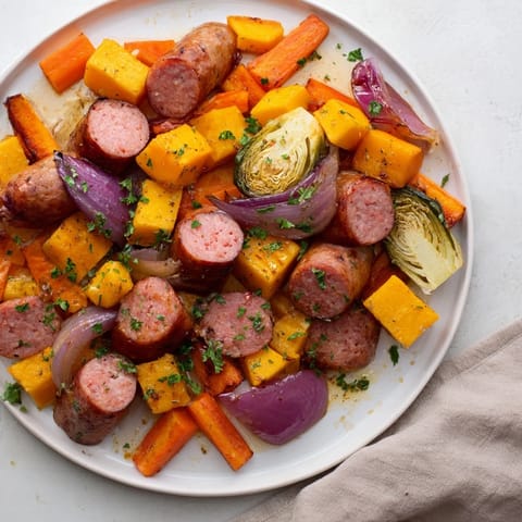 Vibrant image of seasoned sheet pan sausage and autumn veggie medley, perfect for a fall feast.