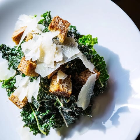 Fresh and vibrant Kale Caesar Salad features massaged kale, creamy dressing, crunchy croutons, and Parmesan.