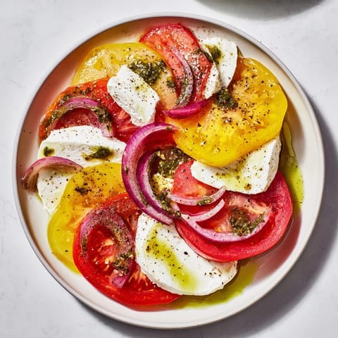 Cool, creamy mozzarella melts amidst colorful tomatoes in this simple Summer Tomato Salad.