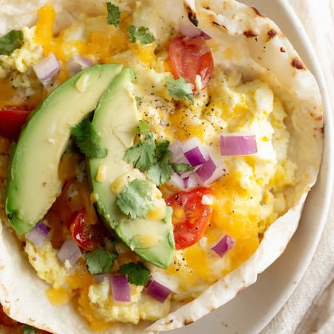 Golden Sheet Pan Breakfast Tacos topped with pico de gallo and cilantro, served hot from the oven.  