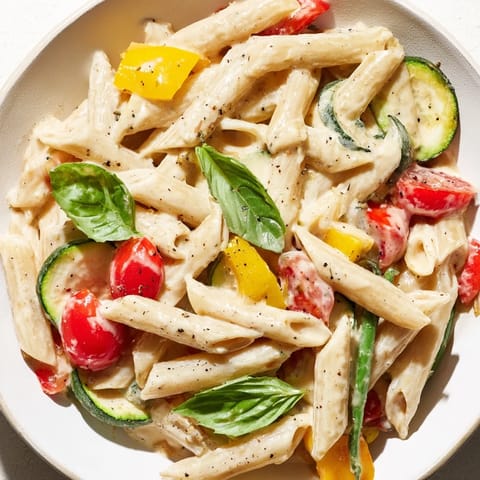 One-Pot Creamy Pasta Primavera served in a bowl with fresh basil garnish and al dente penne.  