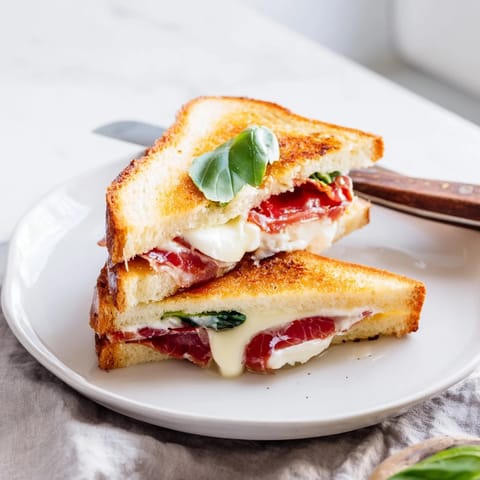 Melted burrata and crisp prosciutto tucked inside a toasted Italian-American sandwich.