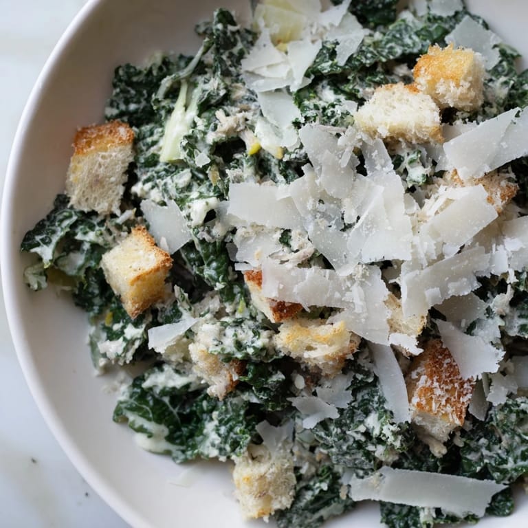 Homemade Kale Caesar Salad, served in a bowl, showcasing massaged kale and a light, flavorful dressing.
