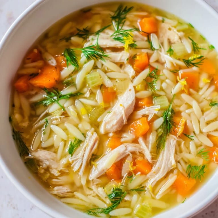 Comforting Chicken Lemon Orzo Soup garnished with parsley, showcasing zesty lemon broth and perfectly cooked orzo pasta.