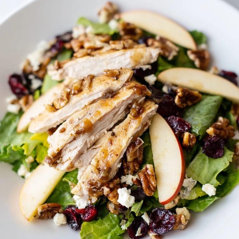 Autumn-inspired Caramel Apple Chicken Salad with goat cheese crumbles and a glossy caramel-pecan dressing, ready to serve.