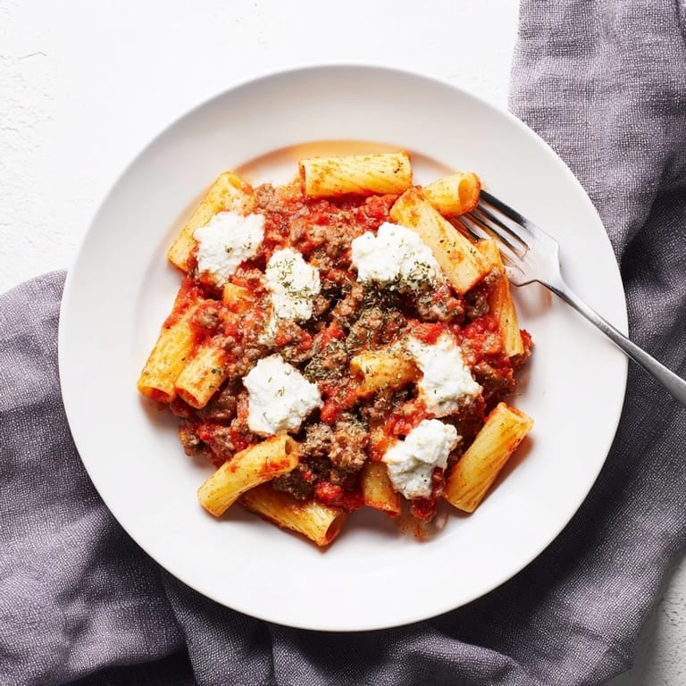 Golden, cheesy ziti in a baking dish with red sauce, ideal for freezing and reheating for busy weeknights.