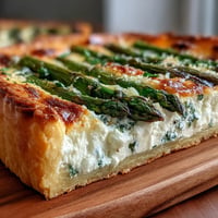 Golden Asparagus Ricotta Tart with vibrant green spears, perfect for brunch.