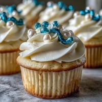 Soft vanilla Cancer birthday cupcakes topped with elegant pearl fondant, perfect for a festive treat.